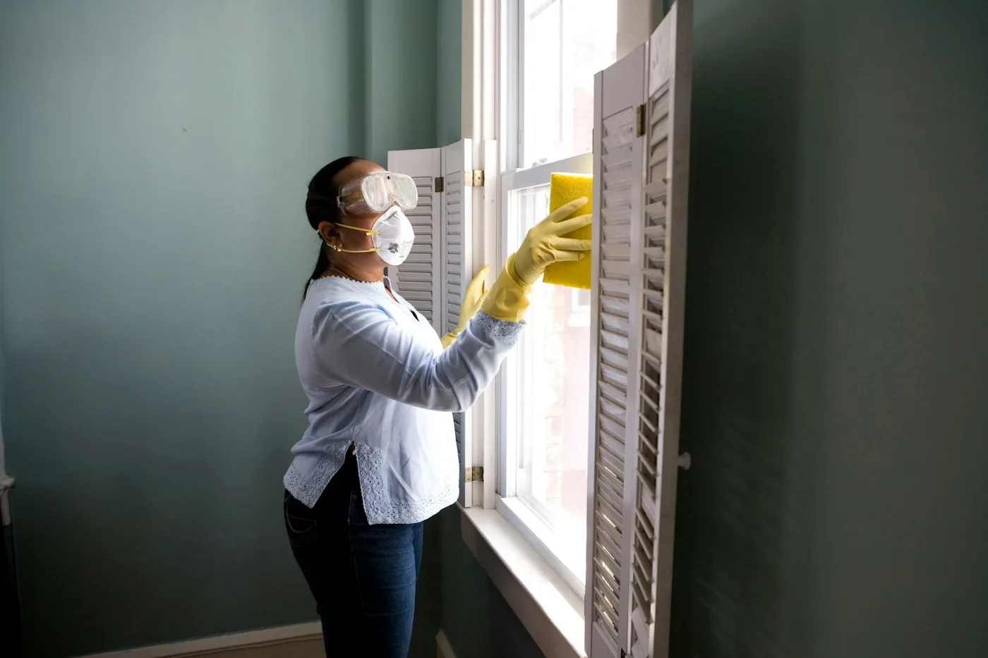 Cleaner wiping a window frame